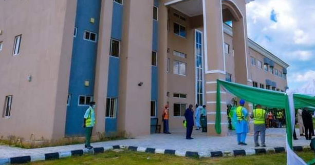 a group of people outside of an administrative building at Aliko Dangote University of Science and Technology