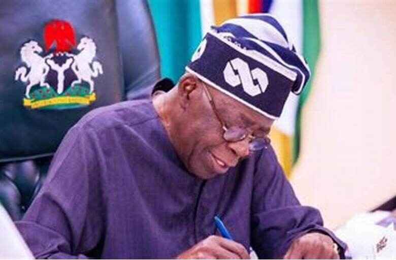 Photo of President Bola Tinubu signing a bill into law